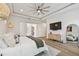 Comfortable main bedroom with a large bed, ensuite bathroom, TV and wooden floor at 3607 W Roland St, Tampa, FL 33609