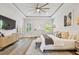Bright and stylish main bedroom featuring a large bed, natural light, and neutral decor at 3607 W Roland St, Tampa, FL 33609