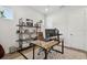 A home office features a wood desk, book shelves, white walls and a geometric rug at 3607 W Roland St, Tampa, FL 33609