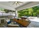 Covered patio with dining area and outdoor kitchen featuring stainless steel grill with view of pool at 3607 W Roland St, Tampa, FL 33609