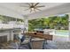 Covered outdoor dining area with a built-in grill and a view of the pool at 3607 W Roland St, Tampa, FL 33609
