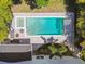 Aerial view of the backyard showcasing the pool, spa, patio and tropical landscaping at 3607 W Roland St, Tampa, FL 33609