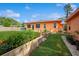 Lush backyard showcasing the home's exterior, garden beds, and well-maintained lawn at 413 Blackburn Rd, Nokomis, FL 34275