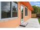 Exterior of the house with a backyard patio, lush landscaping, and natural light at 413 Blackburn Rd, Nokomis, FL 34275