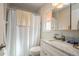 Bathroom featuring a white vanity with marble countertop, toilet and shower with curtain at 413 Blackburn Rd, Nokomis, FL 34275