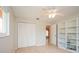 Bedroom showcasing a closet, built-in shelving, hardwood floors and bright natural light at 413 Blackburn Rd, Nokomis, FL 34275