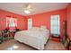 Cozy bedroom featuring hardwood floors, a ceiling fan, and natural light from two windows at 413 Blackburn Rd, Nokomis, FL 34275