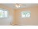 A bright bedroom with two windows and light hardwood floors, freshly painted at 413 Blackburn Rd, Nokomis, FL 34275