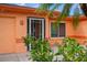 Close up of home entrance and blooming vegetation at 413 Blackburn Rd, Nokomis, FL 34275