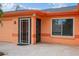 Welcoming front entrance featuring a paved walkway, a secure screen door, and a well-maintained facade at 413 Blackburn Rd, Nokomis, FL 34275