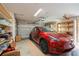 A Tesla parked inside of a garage with shelves and storage at 413 Blackburn Rd, Nokomis, FL 34275