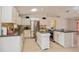 Well-lit kitchen with white cabinets, stainless steel appliances, and countertop island at 413 Blackburn Rd, Nokomis, FL 34275