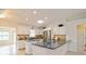 Modern kitchen with white cabinets, stainless steel appliances, and a skylight at 413 Blackburn Rd, Nokomis, FL 34275