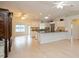 Bright, open-concept kitchen with white cabinets, stainless steel appliances, and hardwood floors at 413 Blackburn Rd, Nokomis, FL 34275