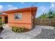 A stone walkway and rock garden lead to a side entrance, framed by lush greenery at 413 Blackburn Rd, Nokomis, FL 34275