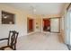 Sunny sunroom with backyard access, window to kitchen, slider to bedroom, and stylish wood flooring at 413 Blackburn Rd, Nokomis, FL 34275