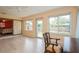Inviting sunroom with door to backyard and slider to bedroom, ceiling fan, and light wood floor at 413 Blackburn Rd, Nokomis, FL 34275