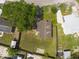 Backyard view reveals a grass lawn, mature tree, fence, and roof features at 4507 26Th S Ave, Tampa, FL 33619