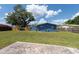 Wide backyard view showcases the expansive green lawn with partial patio, ideal for relaxation and entertainment at 4507 26Th S Ave, Tampa, FL 33619