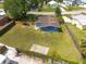 Backyard view reveals a grass lawn, fence, roof features, and privacy at 4507 26Th S Ave, Tampa, FL 33619