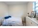 Cozy bedroom with a twin bed, dresser, and bright window view at 4507 26Th S Ave, Tampa, FL 33619
