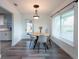 Cozy dining area with a round table, modern chandelier, and ample natural light at 4507 26Th S Ave, Tampa, FL 33619