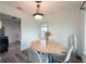 Cozy dining area with a round table, modern chandelier, and ample natural light at 4507 26Th S Ave, Tampa, FL 33619