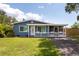 Charming single-story home with a welcoming front porch and manicured lawn at 4507 26Th S Ave, Tampa, FL 33619
