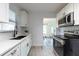 Well-lit kitchen featuring stainless steel appliances and white cabinetry with dark hardware at 4507 26Th S Ave, Tampa, FL 33619