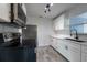 Well-lit kitchen featuring stainless steel appliances and white cabinetry with dark hardware at 4507 26Th S Ave, Tampa, FL 33619