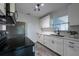 Updated kitchen featuring white cabinets, modern appliances, and stylish backsplash at 4507 26Th S Ave, Tampa, FL 33619