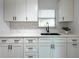 Bright kitchen featuring sleek white countertops and modern cabinetry with dark hardware at 4507 26Th S Ave, Tampa, FL 33619