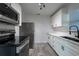 Well-lit kitchen featuring stainless steel appliances and white cabinetry with dark hardware at 4507 26Th S Ave, Tampa, FL 33619