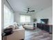 Comfortable living room with a plush sofa, modern ceiling fan, and stylish accents at 4507 26Th S Ave, Tampa, FL 33619