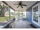 Large screened-in patio featuring tiled ceiling, furniture, and bright sunlight at 4507 26Th S Ave, Tampa, FL 33619