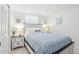 Bright bedroom with blue decor, tile flooring, closet, and a bedside table at 4902 Blue Heron Dr, New Port Richey, FL 34652