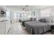 Light bedroom features two beds, beach-themed decor, tile flooring, and a TV for relaxing entertainment at 4902 Blue Heron Dr, New Port Richey, FL 34652