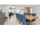 Dining room features tiled floors, wood table and blue chairs at 4902 Blue Heron Dr, New Port Richey, FL 34652