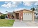 Charming single-Gathering home with a brick facade, well-maintained lawn, and attached garage at 4902 Blue Heron Dr, New Port Richey, FL 34652