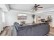 Cozy living room featuring hardwood floors, a ceiling fan, and an open layout at 4902 Blue Heron Dr, New Port Richey, FL 34652