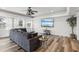 Bright living room featuring hardwood floors, tray ceiling, and lots of natural light at 4902 Blue Heron Dr, New Port Richey, FL 34652