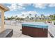Outdoor patio featuring a private hot tub overlooking a waterfront canal and beautiful tropical views at 4902 Blue Heron Dr, New Port Richey, FL 34652