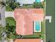 Aerial view of a waterfront property featuring a pool, dock, and meticulously maintained landscaping at 4973 60Th S Ave, St Petersburg, FL 33715