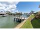 Private dock on a tranquil canal with lush tropical landscaping and beautiful homes in the background at 4973 60Th S Ave, St Petersburg, FL 33715