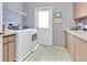 Functional laundry room with modern appliances, ample counter space, and convenient outdoor access at 4973 60Th S Ave, St Petersburg, FL 33715