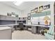 Spacious office with built-in shelving, a large desk area, and natural light from the window at 4973 60Th S Ave, St Petersburg, FL 33715