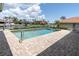 Private pool with a beautiful waterfront view, surrounded by a brick patio and lush tropical plants at 4973 60Th S Ave, St Petersburg, FL 33715