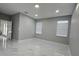 Bright, airy room with white marble floors, neutral walls, and abundant natural light from two windows at 5180 69Th N Ave, Pinellas Park, FL 33781