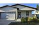 Charming single-story home featuring an attached garage, covered entry, and beautifully landscaped front yard at 5180 69Th N Ave, Pinellas Park, FL 33781