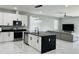 Stylish kitchen featuring a center island, modern appliances, and a seamless transition to the living area at 5180 69Th N Ave, Pinellas Park, FL 33781